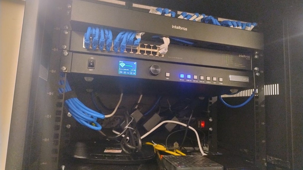 Rack com patch panel Cat6, switch Intelbras e cabeamento estruturado executado pela Master Vácuo